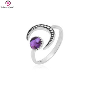 Sterling silver crescent moon ring with natural amethyst gemstone worn on woman’s hand in soft natural light